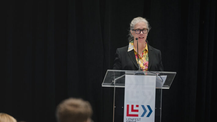 Annie McCain speaking at a podium at the 2026 Lenfest News Philanthropy Summit
